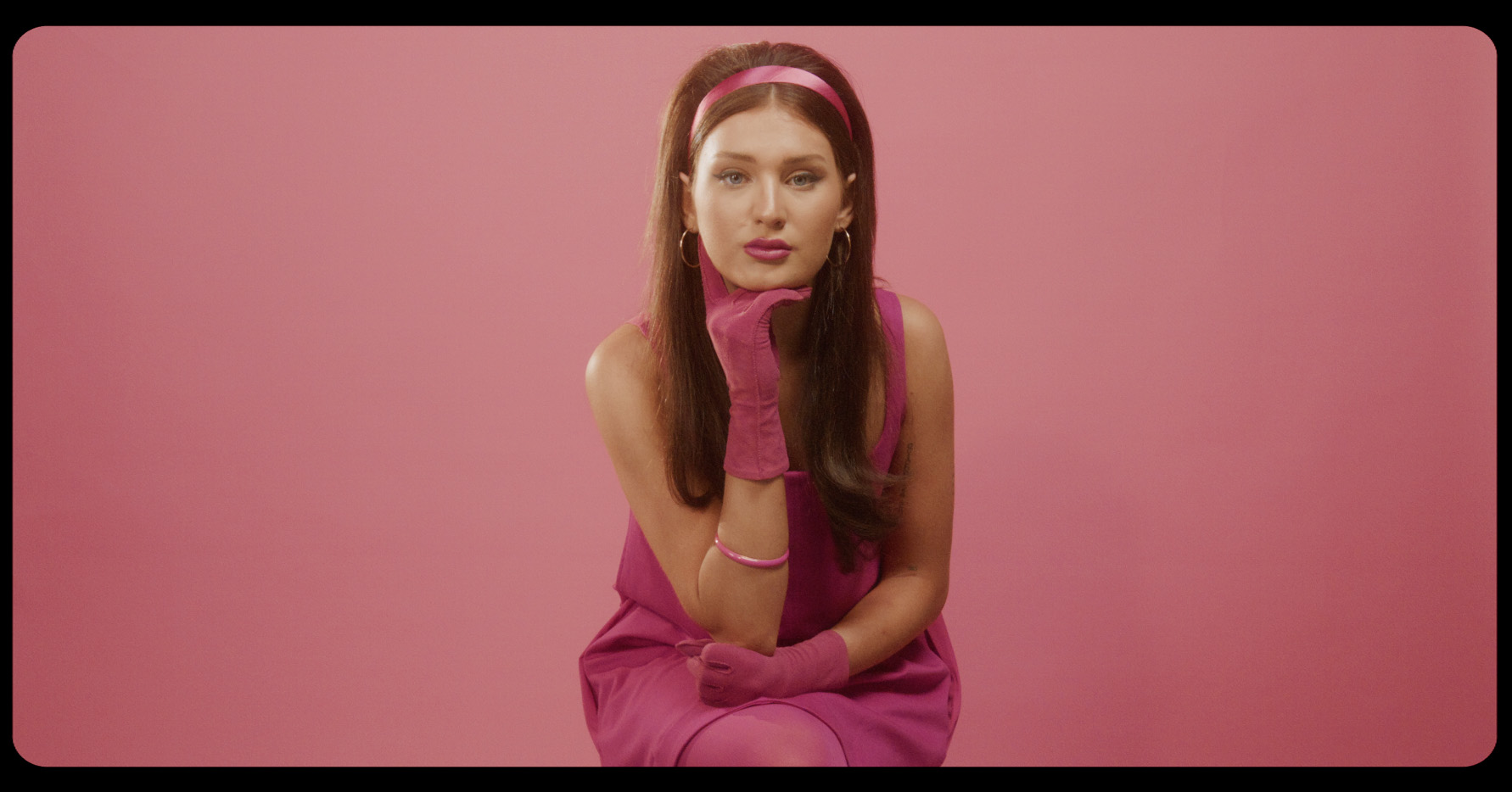 From the Don’t Call Me music video: maryjo in pink retro attire.